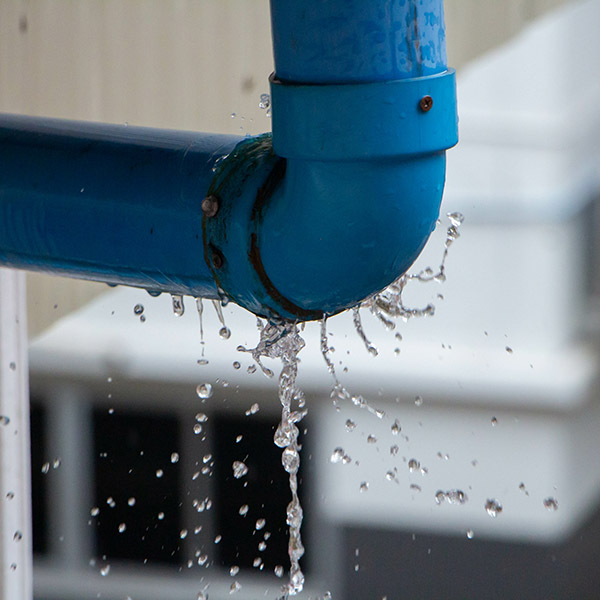 Blue pipe leaks water.