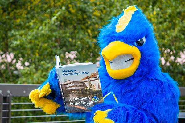 Mascot reading the A diamond in the rough book