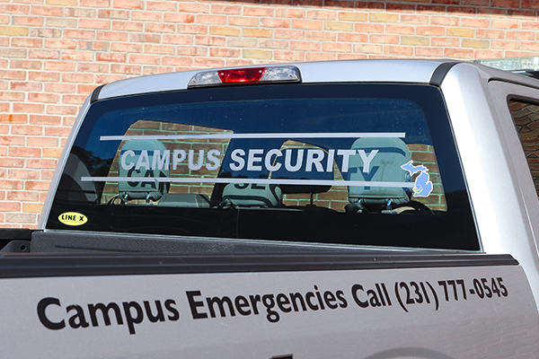 Campus security vehicle with emergency number on the side. That number is 1-231-777-0545